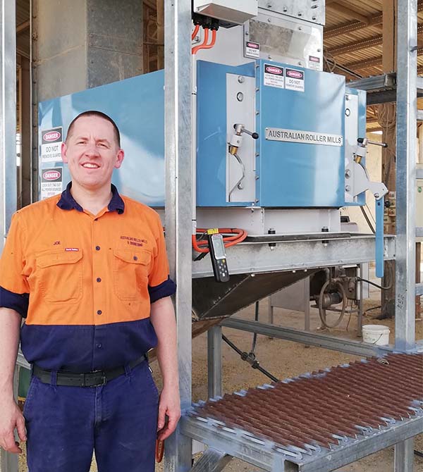 Joe from Australian Roller Mills standing in front of machinery