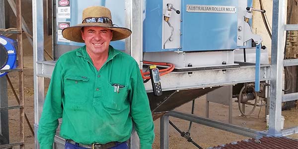 Phillip Coggan standing in front of machinery